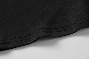 Detailed macro view showing high-quality double-stitch sewing on black pleated dress fabric