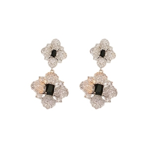 Silver flower stud earrings set with sparkling zircons and a central black rectangular gem