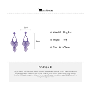 Macro detail of purple hollow leaf earrings with dimensions 6cm by 2cm and alloy material