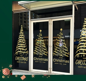 Detail of golden static Christmas tree stickers on glass door for holiday shop decoration