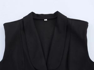 Close-up of the black V-neck collar and size S tag on a sleeveless vest suit top