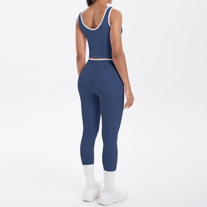 Detail of navy yoga set with white contrast trim on high waist leggings and sports bra