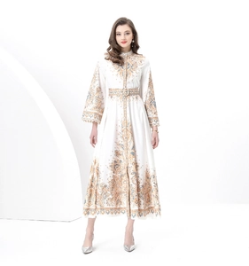 Detail of bohemian print and lace cuffs on a white long-sleeved retro maxi dress