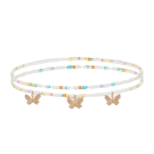 Détail macro d'une chaîne de corps perlée colorée avec pendentifs papillons dorés