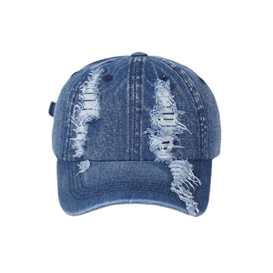 Distressed navy denim baseball cap with vintage frayed rips and retro streetwear style