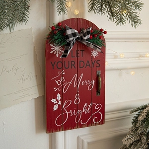 Wooden Christmas door sign with Merry and Bright quote, red berries, and festive bow