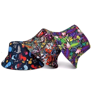 Detailed view of various printed bucket hats featuring sharks, skulls, and flamingos