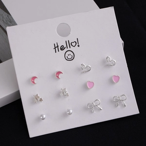 Detail view of 6-pair earring set featuring pink enamel moon and heart designs on card