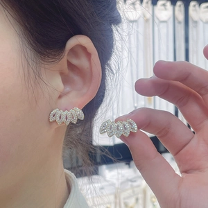 Elegant 18k gold plated crown stud earrings with sparkling cubic zirconia on model