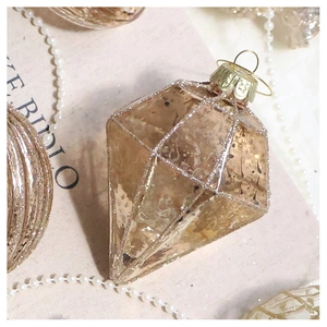 Macro shot of champagne gold faceted Christmas ornament with glitter and grid detail
