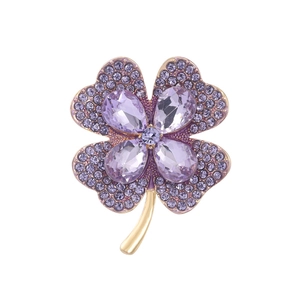 Elegant four-leaf clover brooch with purple crystal petals and gold-plated finish