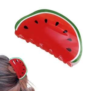 Detail of watermelon claw clip featuring red and green acrylic with black seed accents