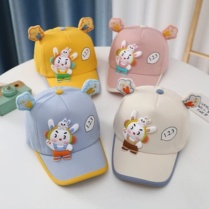 Close-up of four colorful toddler baseball hats with cute 3D bunny appliques and cloud ears