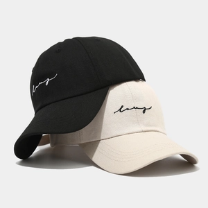 Black and beige baseball caps with embroidery featuring classic cotton twill material