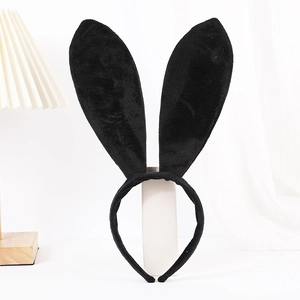 Close-up of cute plush black rabbit ears headband on a white cylindrical display stand