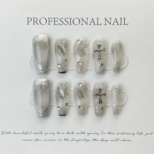 Handmade press-on nails featuring silver cross decor and gray marble ink texture