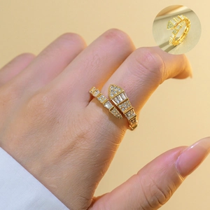 Detail of gold snake ring with white zircon stones and adjustable layered snake band