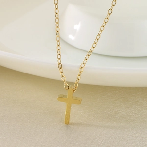 Minimalist gold stainless steel cross necklace featuring a sleek cross pendant on a fine chain