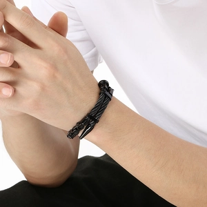 Detailed view of punk style double-layered black steel wire bracelet with conical spikes
