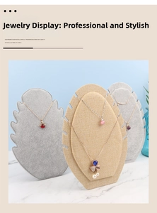 Detail showing shell-shaped velvet and linen necklace display boards with multiple slots