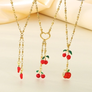 Golden titanium steel necklaces with red cherry, apple, and heart charms on yellow satin