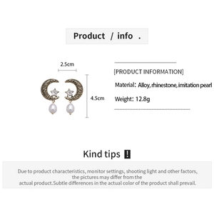 Macro shot showing moon and star earrings dimensions with pearl and rhinestone details