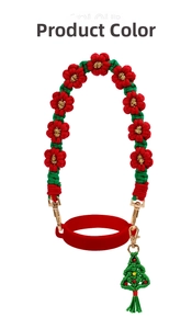 Detail of red and green woven cup strap with floral patterns and Christmas tree charm