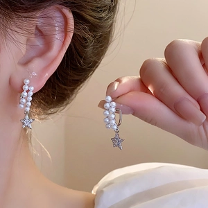 Elegant drop earrings featuring double-row pearls and sparkling star pendants in silver