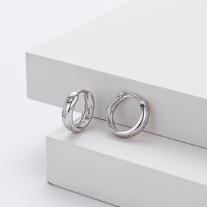 Close-up of S925 sterling silver hoop earrings with hollow stars and micro-pave zircons