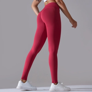 Detail view of burgundy high-waisted seamless yoga leggings with peach butt lift design