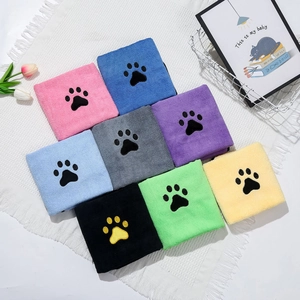Detail of colorful microfiber pet towels with embroidered paw prints on white rug