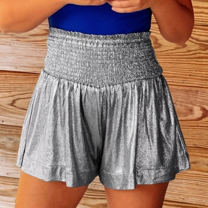 Detail of silver metallic high-waisted shorts featuring an elastic pleated waistband