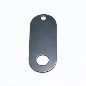 Close-up of a dark grey oval metal tag with two holes on a clean white background