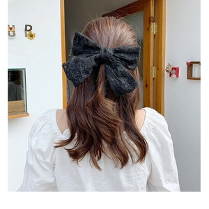Elegant black lace bow hair clip for women featuring long streamers on back of head