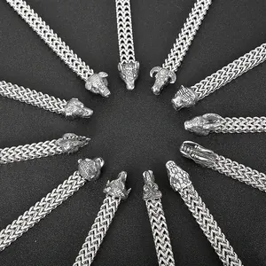 Detail of silver steel bracelets with various animal heads like wolf, bear, and boar designs
