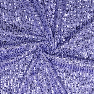 Macro detail of purple sequin fabric with shimmering circular texture for formal gowns