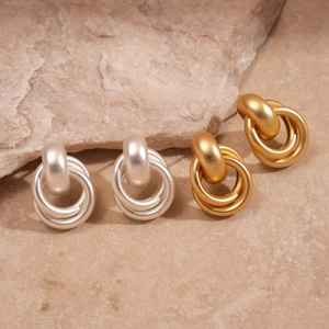 Boucles d'oreilles créoles géométriques mates dorées et argentées sur socle en pierre