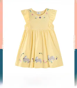 Detail of yellow polka dot dress with colorful floral embroidery and rabbit motifs