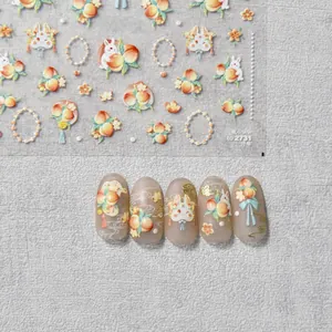 Detail of embossed nail art stickers featuring rabbit, peach, and pearl chain motifs