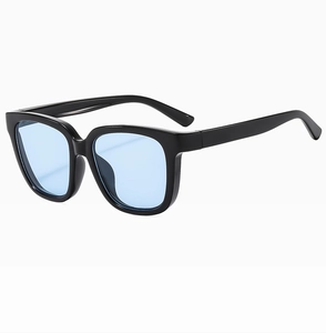 Detail view of stylish square sunglasses featuring glossy black frames and blue lenses