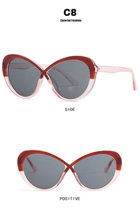 Detail view showing cross bridge design and bicolor frame in dark red and transparent pink