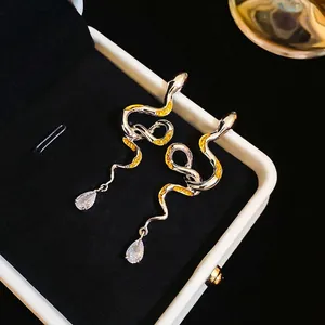 Silver snake drop earrings with yellow enamel patterns and sparkling pear-cut zircon crystals