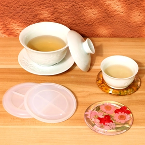 DIY round silicone resin coasters molds with floral resin art on a wooden table