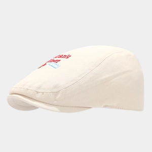 Dettaglio cappello piatto beige con ricamo Jean's Diner rosso e grafica blu ricamata