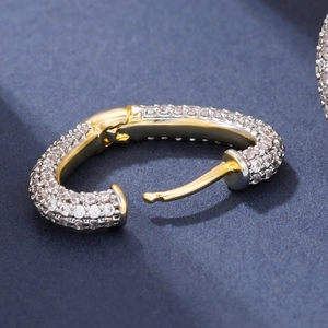 U-shaped huggie earrings with white zircon pavé and gold-silver dual-tone finish