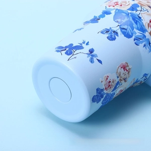 Detailed macro view of the anti-slip base and vintage floral pattern on the blue tumbler