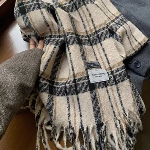 Detail of vintage plaid scarf with soft fringe edge and thick woven check texture
