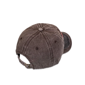 Detail view of the washed cotton baseball cap featuring vintage frayed edges and metal buckle