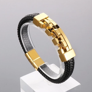 Detail of black braided leather men's bracelet with gold stainless steel lock buckle