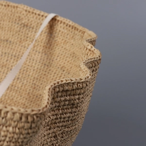Elegant natural raffia straw hat for women with wavy brim detail for beach sun protection